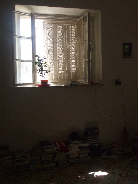 Light comes in through the shutters of an apartment window