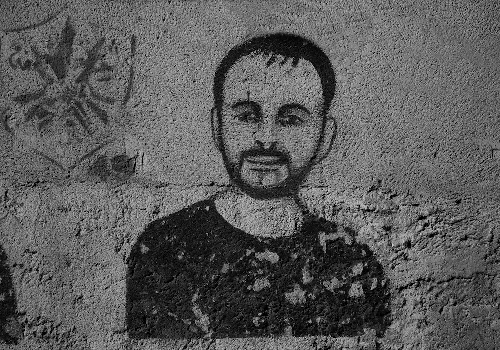 Drawing of Palestinian writer Nasser Abu Srour on the wall of a building in the Aida refugee camp near Nasser’s family home in the West Bank.