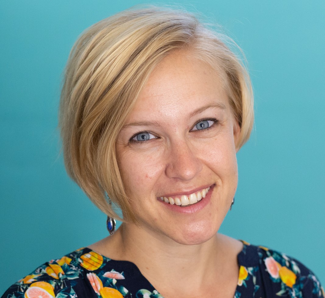 Portrait of Elisabeth Jaquette against a light blue background. 